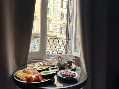 a tray of food on a table in a room with a window at Candia41 in Rome