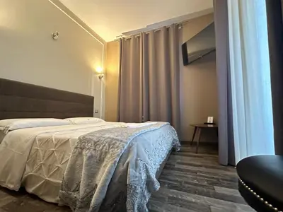 a bedroom with a bed with a blanket on it at Candia41 in Rome