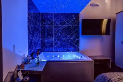 a bathroom with a tub with a blue ceiling at Relais Incantesimo Vaticano in Rome