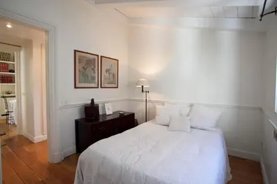 a white bedroom with a bed and a table at Terrace Jewel by Campo de Fiori in Rome