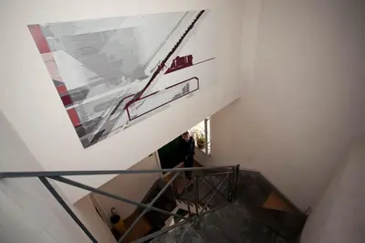 a person walking down a stairs with a painting on the wall at Terrace Jewel by Campo de Fiori in Rome