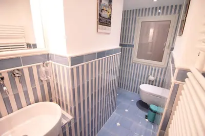 a bathroom with a toilet and a sink at Spanish Steps Art Apartment in Rome
