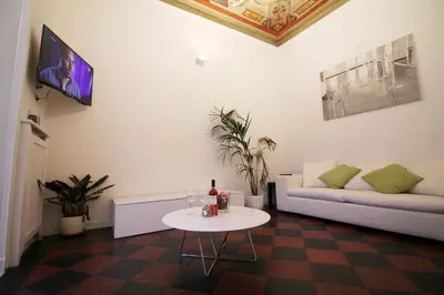 a living room with a couch and a table at Spanish Steps Art Apartment in Rome