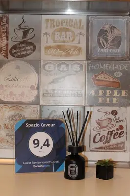 a wall with alot of signs and a vase with sticks at Spazio Cavour Guesthouse in Rome
