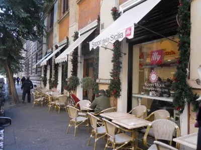 a group of tables and chairs outside of a store at Spazio Cavour Guesthouse in Rome