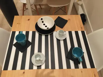 a table with plates and bowls on a striped table cloth at Spazio Cavour Guesthouse in Rome