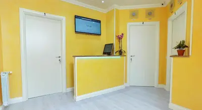 a room with two white doors and a yellow wall at Termini Suites in Rome