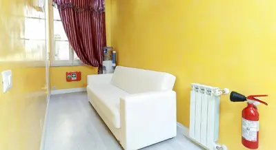a room with a fire extinguisher in a room with yellow walls at Termini Suites in Rome