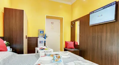 a room with a bed and a flat screen tv at Termini Suites in Rome