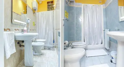 a bathroom with two toilets and a sink and a shower at Termini Suites in Rome