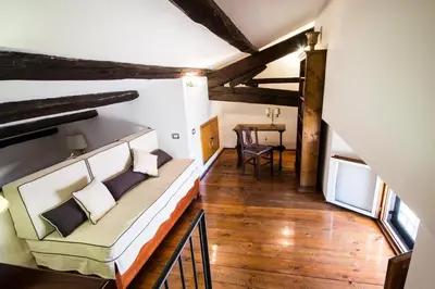 an attic room with a couch and a table at Altieri Loft Pantheon in Rome