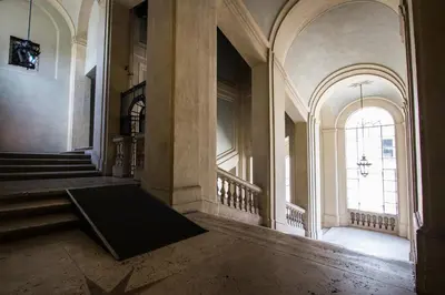 an empty hallway of a building with a large window at Altieri Loft Pantheon in Rome
