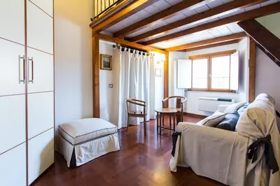 a living room with a couch and a chair at Altieri Loft Pantheon in Rome
