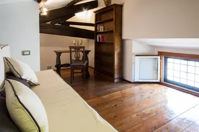 a bedroom with a bed and a wooden floor at Altieri Loft Pantheon in Rome