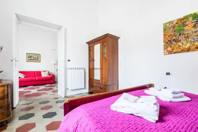 a bedroom with a pink bed with towels on it at Relax Apartment Zanardelli, Piazza Navona in Rome