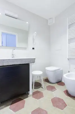 a bathroom with a sink and a toilet and a mirror at Relax Apartment Zanardelli, Piazza Navona in Rome