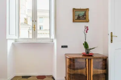 a vase on a table next to a window at Relax Apartment Zanardelli, Piazza Navona in Rome