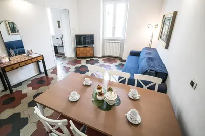 a living room with a table and a blue couch at Relax Apartment Zanardelli, Piazza Navona in Rome