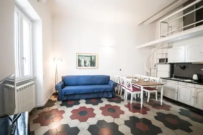 a living room with a blue couch and a table at Relax Apartment Zanardelli, Piazza Navona in Rome