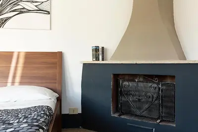 a bedroom with a bed and a fireplace at Tetti di Piazza Navona in Rome