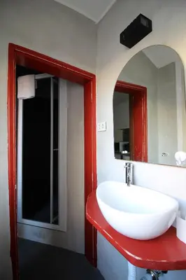 a bathroom with a white sink and a mirror at Tetti di Piazza Navona in Rome