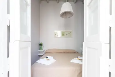 a bedroom with white walls and a bed with towels at Ideal Apartment D'Ascanio, Piazza Navona in Rome