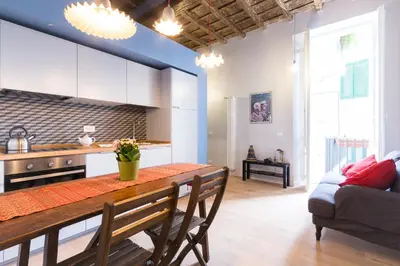 a kitchen and dining room with a table and a couch at Ideal Apartment D'Ascanio, Piazza Navona in Rome
