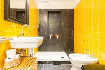 a yellow bathroom with a sink and a toilet at Ideal Apartment D'Ascanio, Piazza Navona in Rome