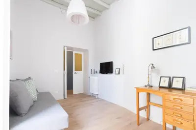 a white living room with a wooden table and a desk at Ideal Apartment D'Ascanio, Piazza Navona in Rome