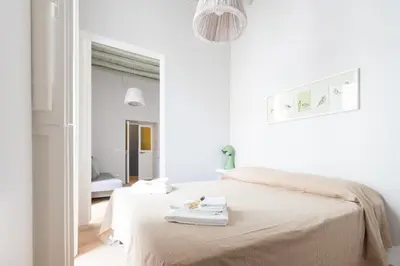 a white room with a bed with towels on it at Ideal Apartment D'Ascanio, Piazza Navona in Rome