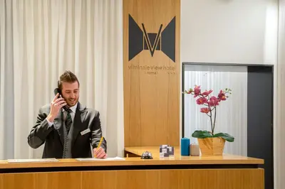 a man in a suit talking on a cell phone at Viminale View Hotel in Rome