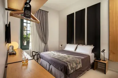 a hotel room with a bed and a desk at Viminale View Hotel in Rome
