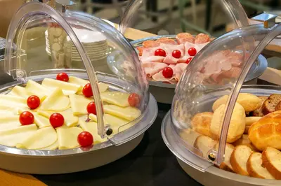 a buffet of different types of food in trays at Viminale View Hotel in Rome