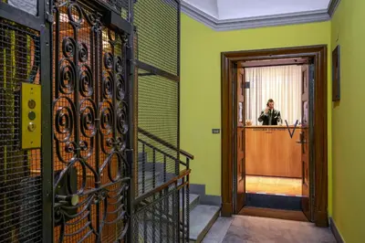 a man is standing in the doorway of a building at Viminale View Hotel in Rome