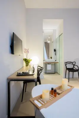 a living room with a table with candles and a room at Viminale View Hotel in Rome