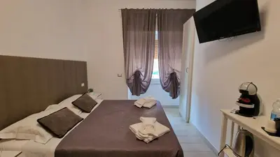 a hotel room with a bed and a television at Mr. Charlie Brown in Rome