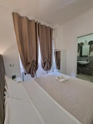 a bedroom with a large white bed with curtains at Mr. Charlie Brown in Rome