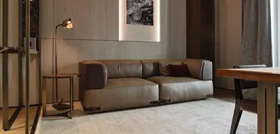 a brown couch in a living room with a lamp at Fendi Private Suites - Small Luxury Hotels of the World in Rome