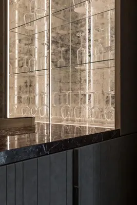 a glass display case with wine glasses on a counter at Fendi Private Suites - Small Luxury Hotels of the World in Rome