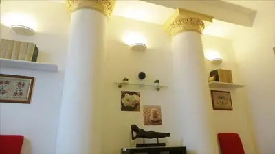 a room with two white columns in a living room at Cuore di Testaccio Apartment in Rome