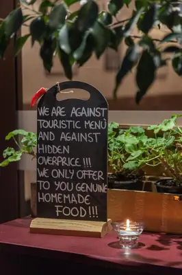 a sign sitting on top of a table with plants at Casa in Monti in Rome