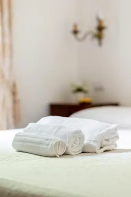 a pair of towels sitting on top of a bed at Casa in Monti in Rome