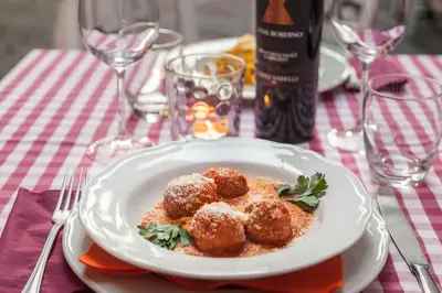a plate of food with meatballs on a table at Casa in Monti in Rome