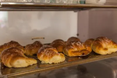 a bunch of loaves of bread sitting on a shelf at Casa in Monti in Rome