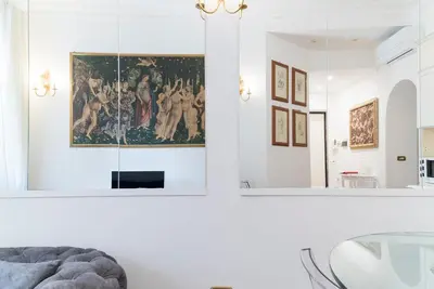 a living room with a painting on the wall and a mirror at Prinsi Apartments in Rome