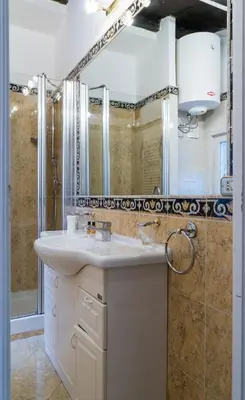 a bathroom with a sink and a mirror at Prinsi Apartments in Rome
