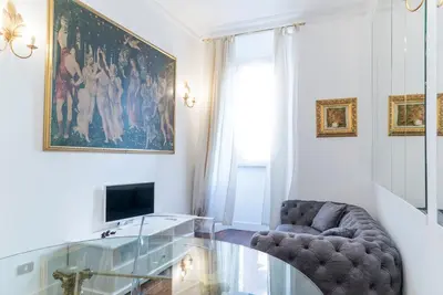 a living room with a chair and a glass table at Prinsi Apartments in Rome