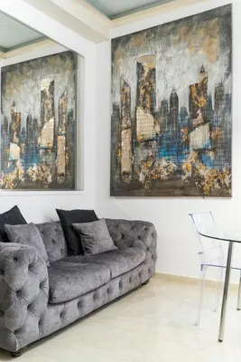 a living room with a couch and a painting at Prinsi Apartments in Rome