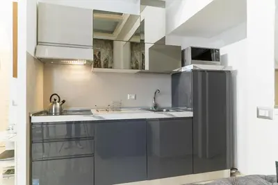 a kitchen with a sink and a refrigerator at Prinsi Apartments in Rome