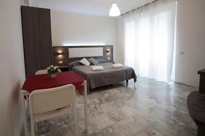 a bedroom with a bed and a table with a red table at B&B Momenti Romani in Rome